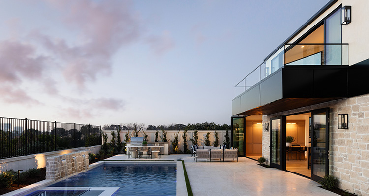 a modern luxury home with a swimming pool, outdoor patio, and a second-story balcony