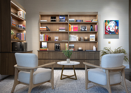 a modern lounge area centered around two white armchairs and a round marble coffee table set against a tall wooden wall unit with built-in shelving