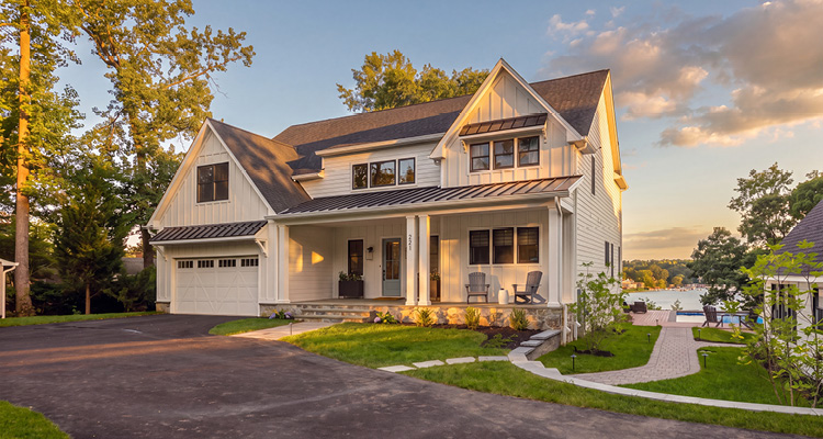 a large, two-story modern farmhouse custom-built along a waterfront property